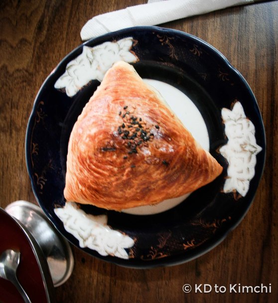 The samsa was made out of flaky pastry, and filled with meat, spices and rice