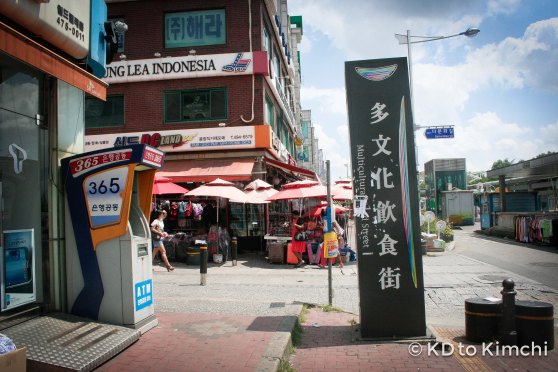 A sign pointing to the main street of the Asian vilalge