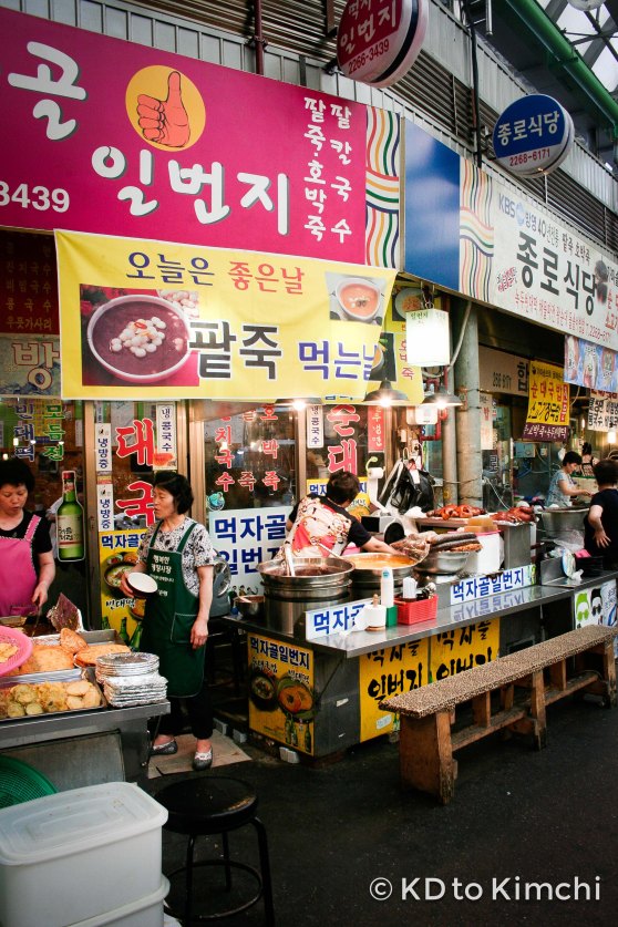 Women selling pumpkin and sweet red bean porridge from giant cauldron-looking things
