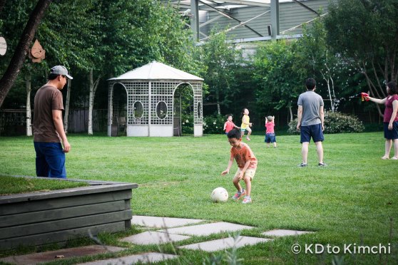Father and son kicking a soccer ball 