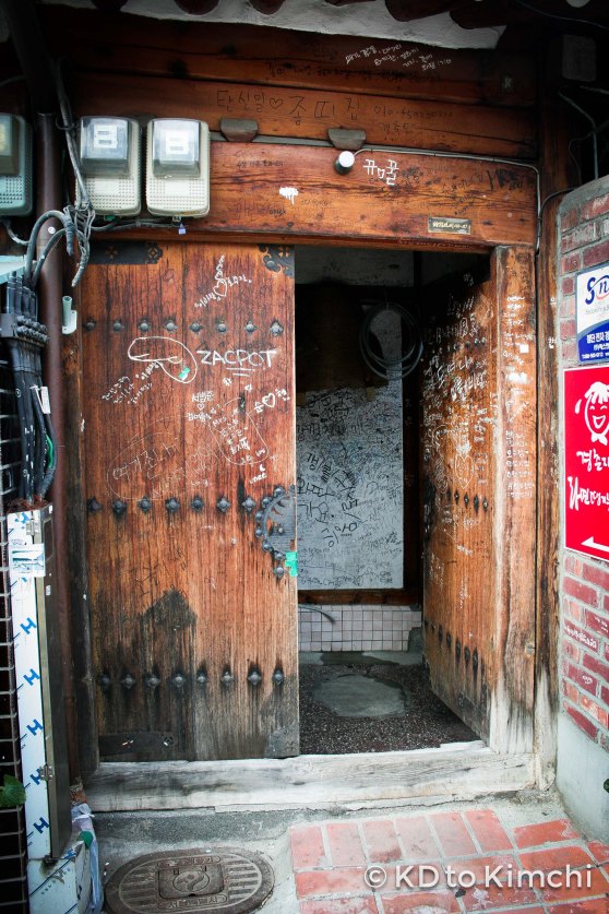 Graffitied doors on a traditional Korean house (hanok) restaurant